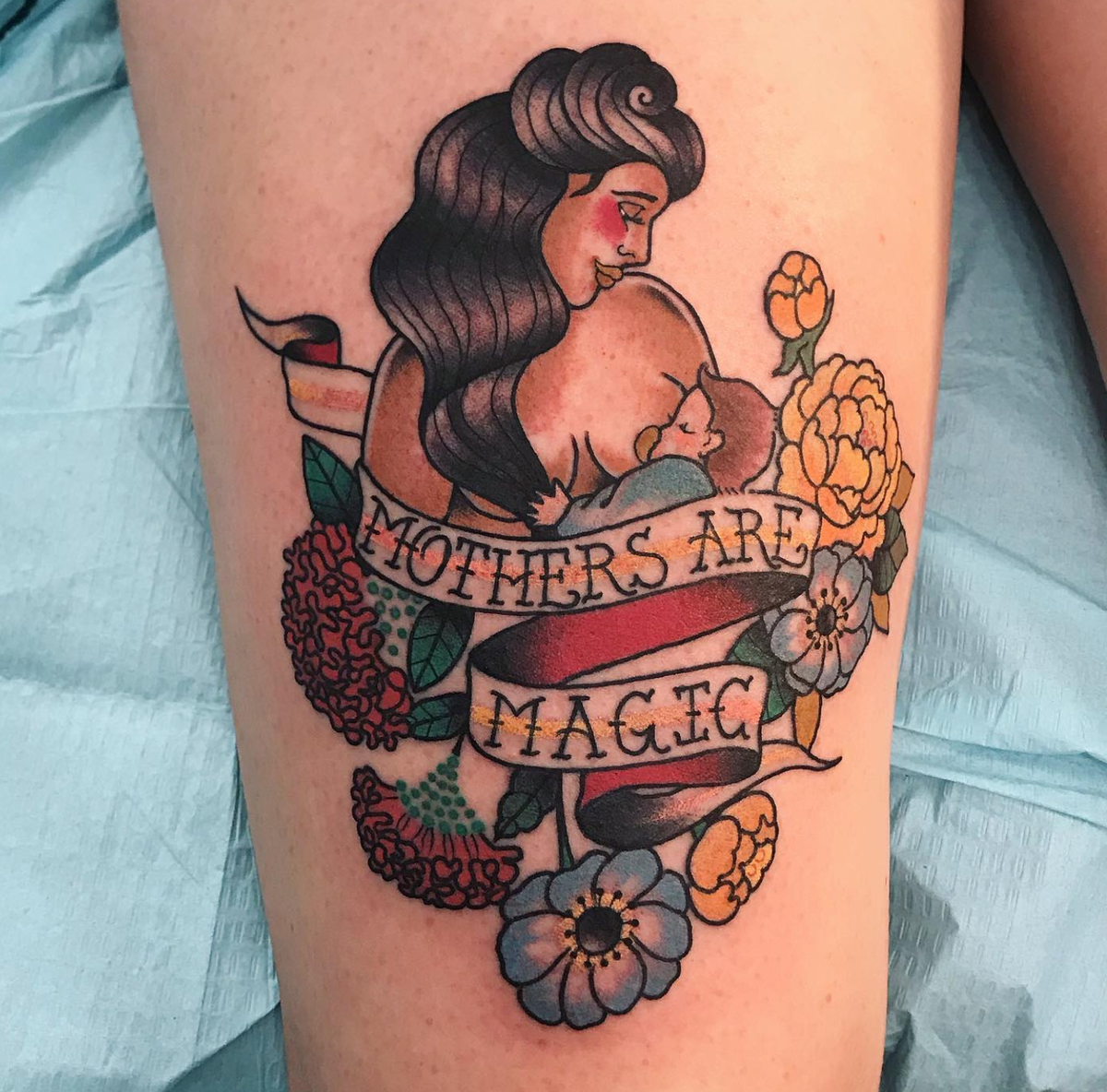 Tattoo of mother breastfeeding her baby with words Mothers are Magic