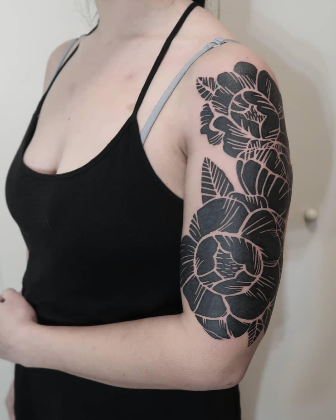 Style focus: White ink on blackout tattoos